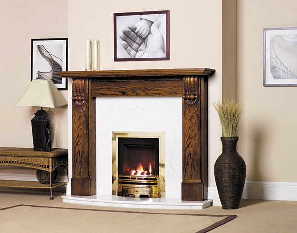 An oak fireplace with a matched pair of large reeded Classical corbels (item code WO656). This fire surround has been stained for a contemporary look.